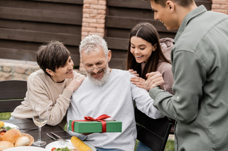 smiling-middle-aged-man-holding-gift-box.jpg